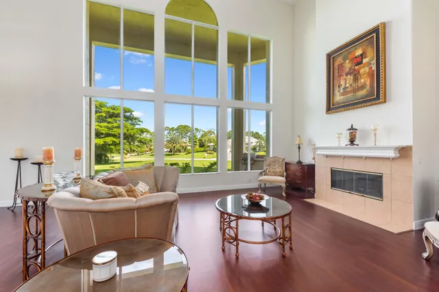 a living room with furniture a window and wooden floor