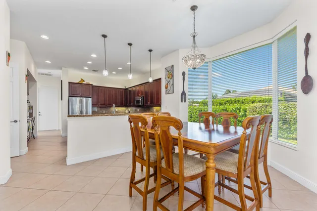 a dining room with furniture and a chandelier
