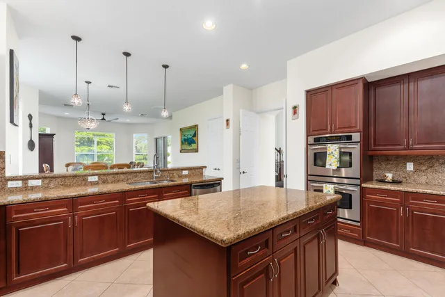 a kitchen with granite countertop stainless steel appliances and wooden cabinets
