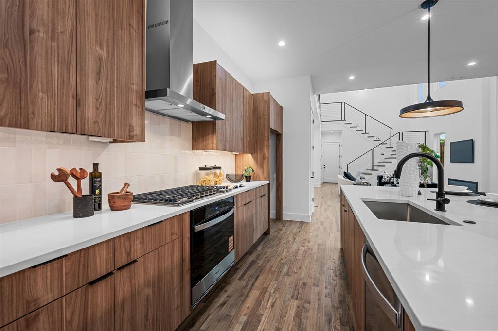 1014 Grandview Avenue Dallas, TX 75223 - Photo 15 of 30 a kitchen with stainless steel appliances granite countertop a sink a stove and a wooden floors