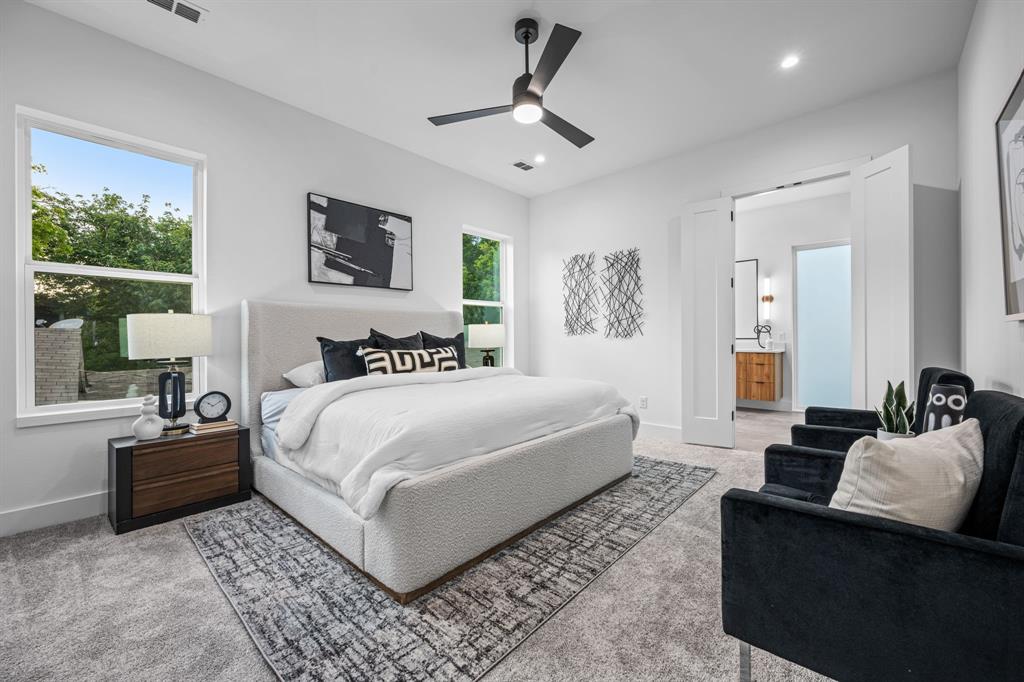 1014 Grandview Avenue Dallas, TX 75223 - Photo 17 of 30 a spacious bedroom with a bed a couch and a large window