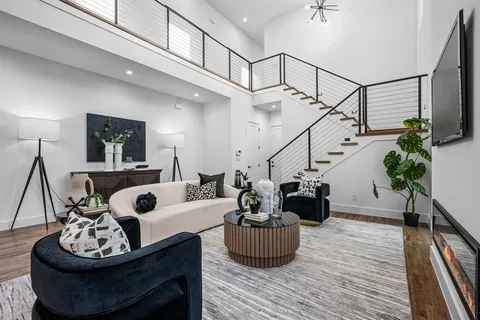 a living room with furniture and kitchen view