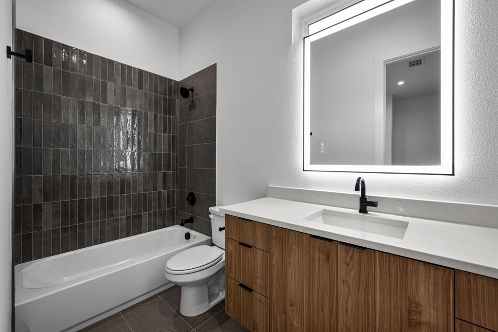 1014 Grandview Avenue Dallas, TX 75223 - Photo 24 of 30 a bathroom with a sink a toilet and shower