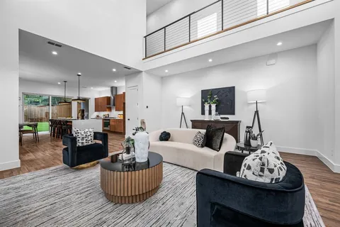 a kitchen with stainless steel appliances granite countertop a stove a refrigerator a kitchen island a table and chairs