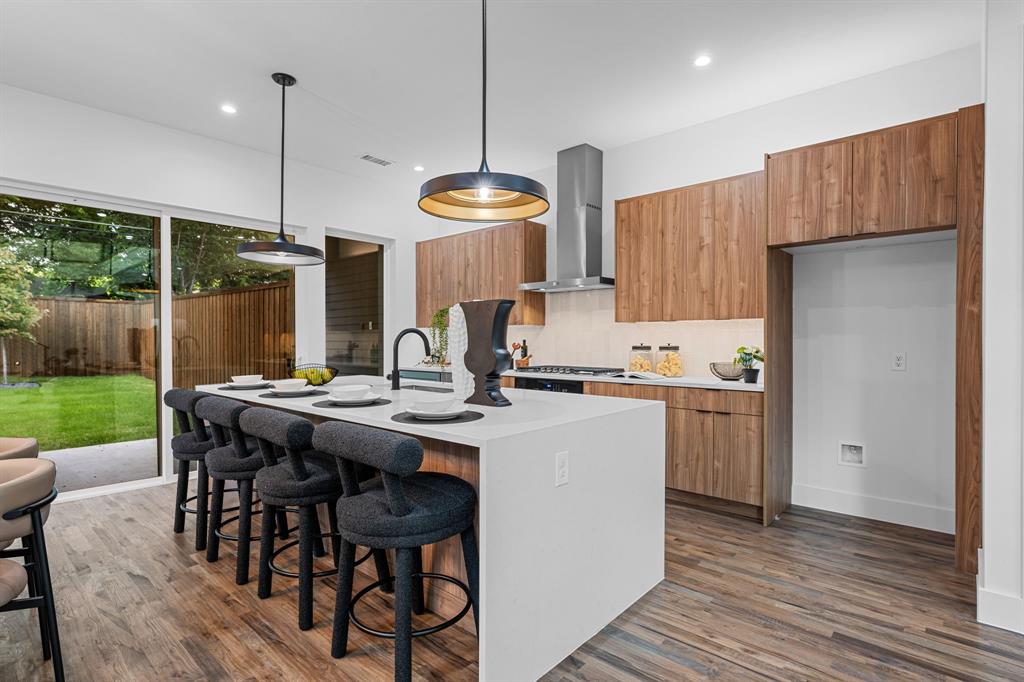 1014 Grandview Avenue Dallas, TX 75223 - Photo 4 of 30 a kitchen with stainless steel appliances granite countertop a stove a refrigerator a kitchen island a table and chairs