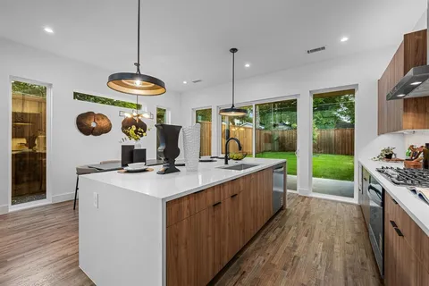 a kitchen with a dining table and chairs