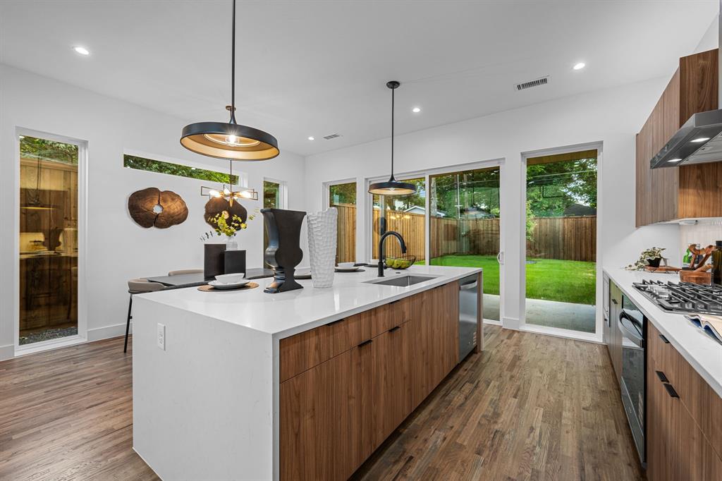 1014 Grandview Avenue Dallas, TX 75223 - Photo 7 of 30 a kitchen with stainless steel appliances granite countertop a sink a stove and a wooden floors