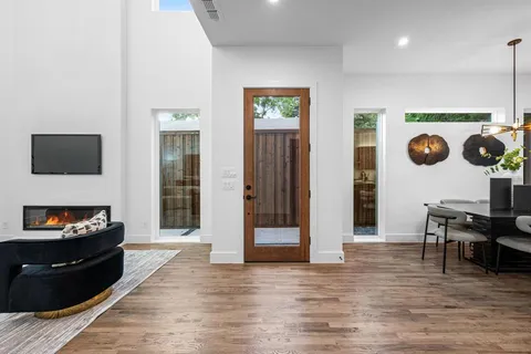 a living room with furniture and a hard wood floor