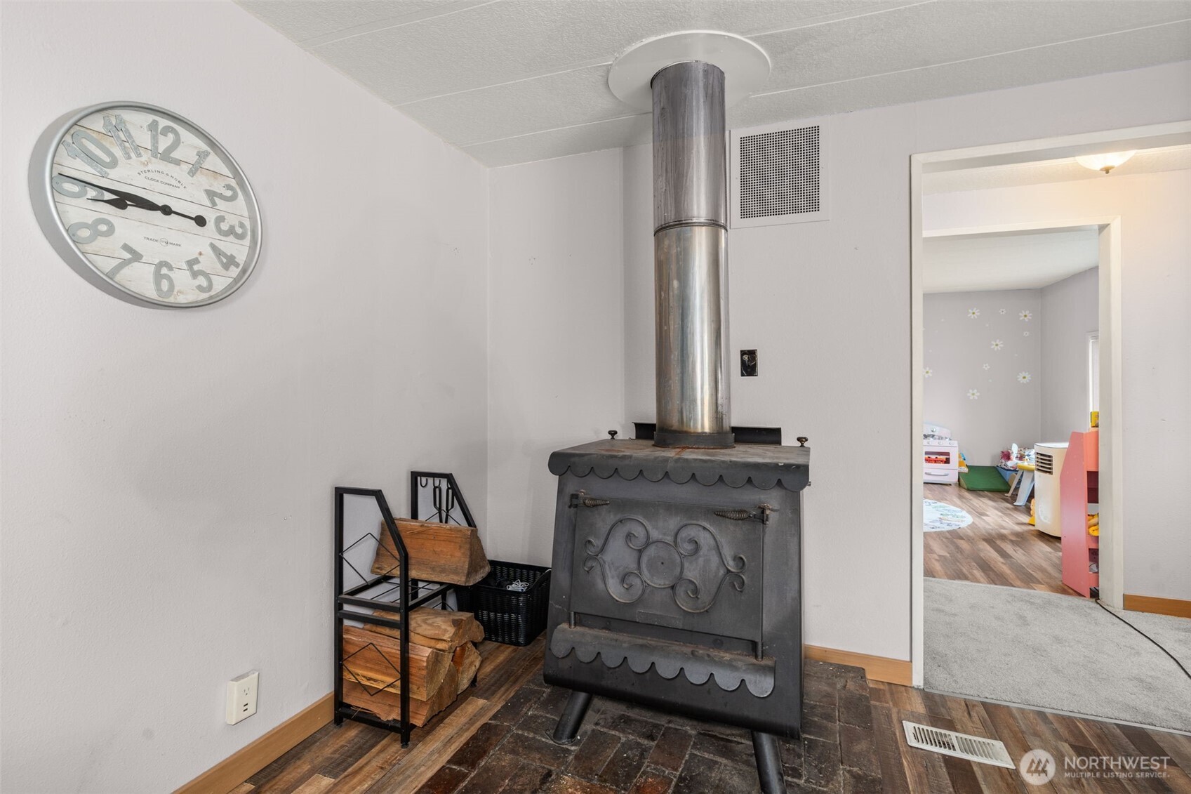 19121 Elderberry Street Southwest Rochester, WA 98579 - Photo 11 of 34 a living room with furniture a clock and a mirror