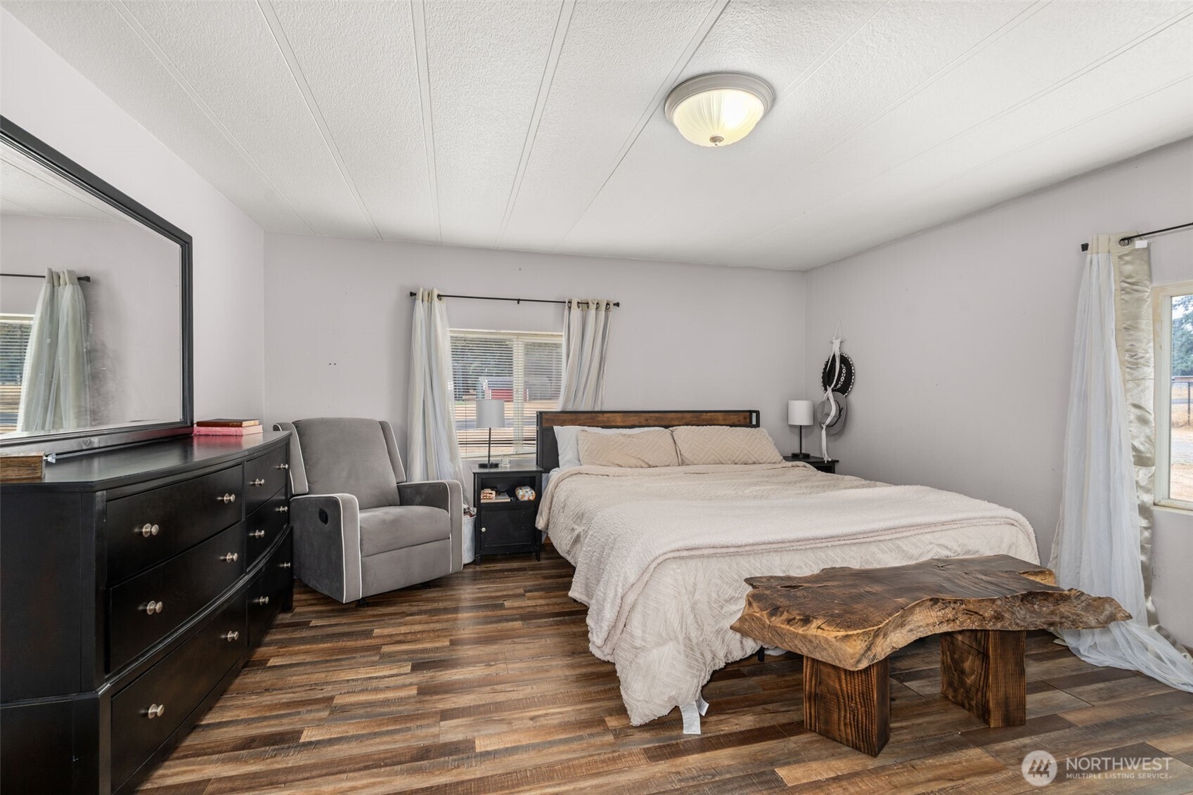 19121 Elderberry Street Southwest Rochester, WA 98579 - Photo 16 of 34 a bedroom with a bed and wooden floor