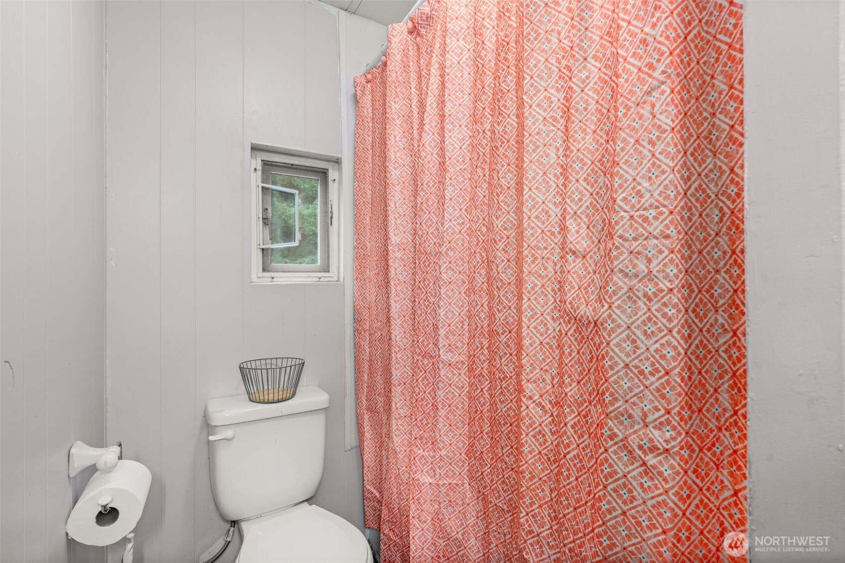 19121 Elderberry Street Southwest Rochester, WA 98579 - Photo 23 of 34 a white toilet sitting next to a shower curtain
