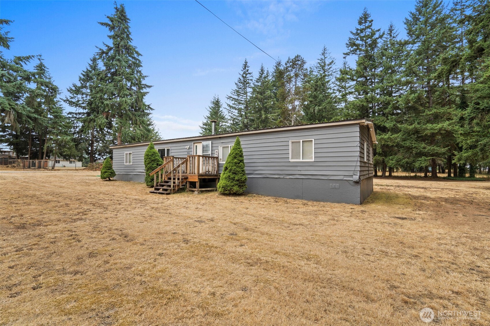 19121 Elderberry Street Southwest Rochester, WA 98579 - Photo 26 of 34 a backyard of a house with garage and deck