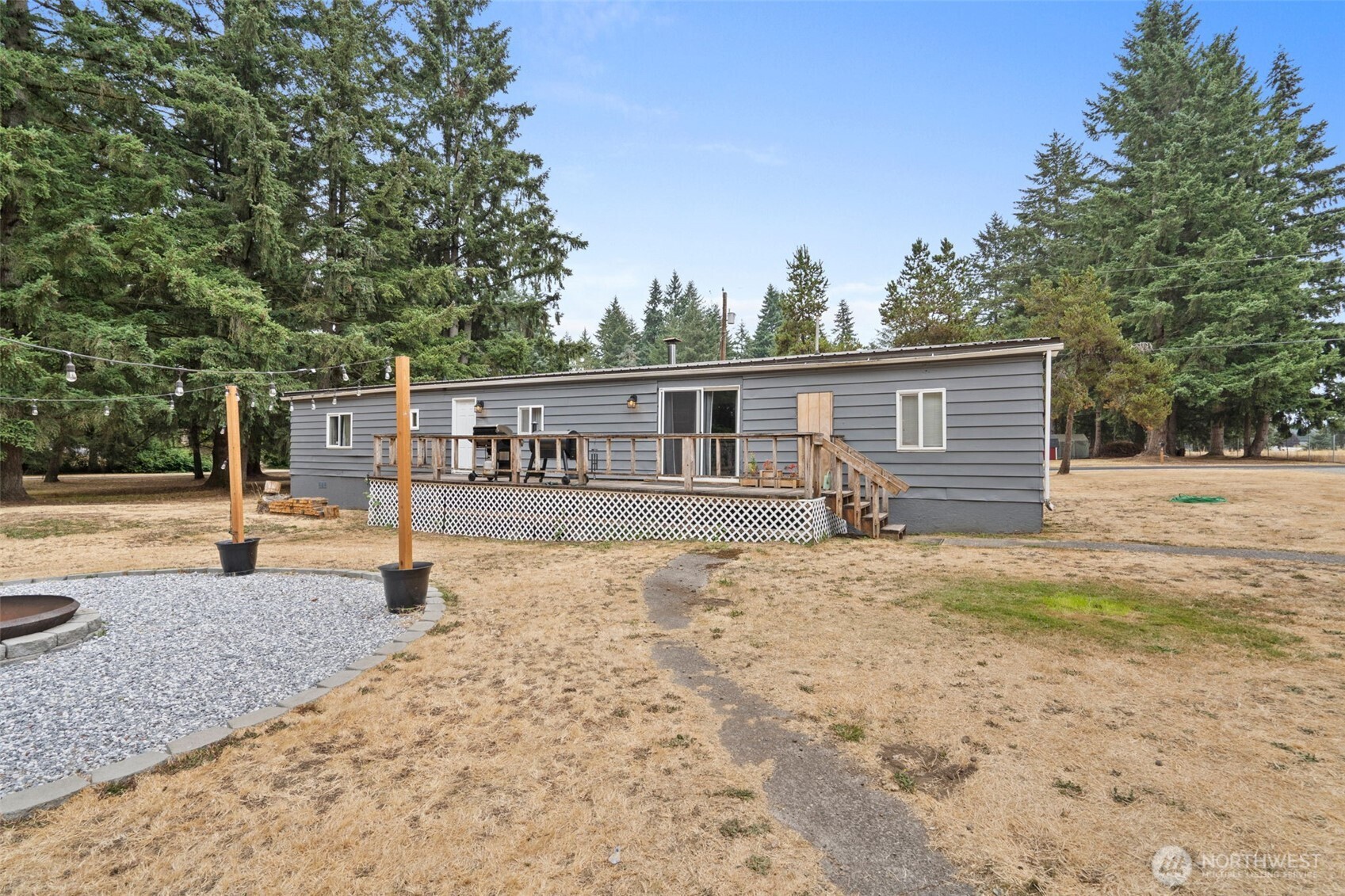 19121 Elderberry Street Southwest Rochester, WA 98579 - Photo 28 of 34 a view of a house with backyard and trees