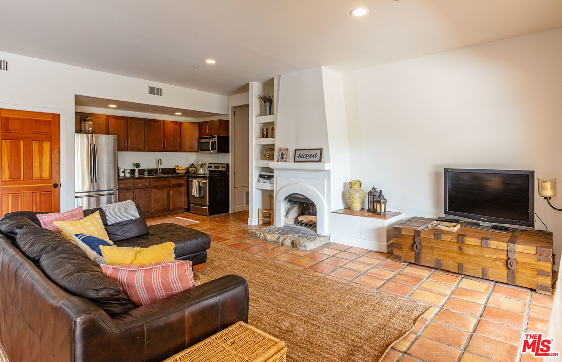 2811 South Foose Road Malibu, CA 90265 - Photo 14 of 24 a living room with fireplace furniture and a flat screen tv