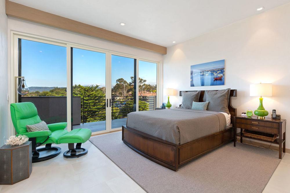201 Cannery Row, Unit 6 Monterey, CA 93940 - Photo 16 of 30 a bedroom with a bed and a large window