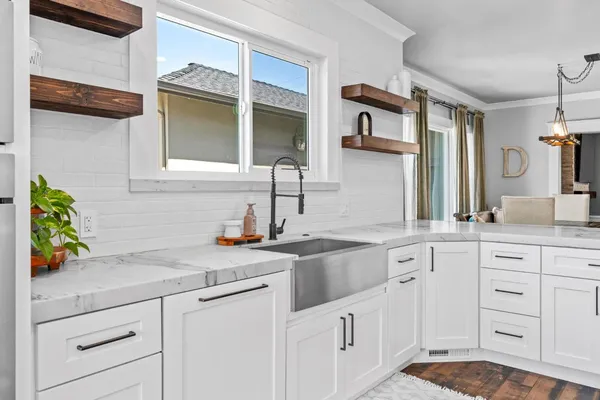a kitchen with white cabinets and appliances
