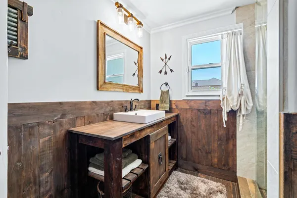 a spacious bedroom with a large bed a flat screen tv and a fireplace