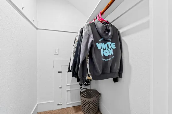 a view of walk in closet with clothes and shoes