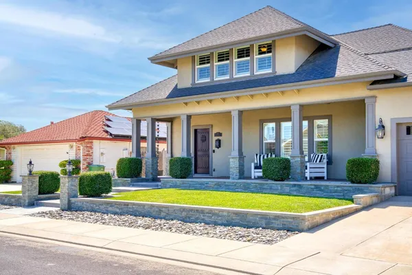 a front view of a house with a fountain