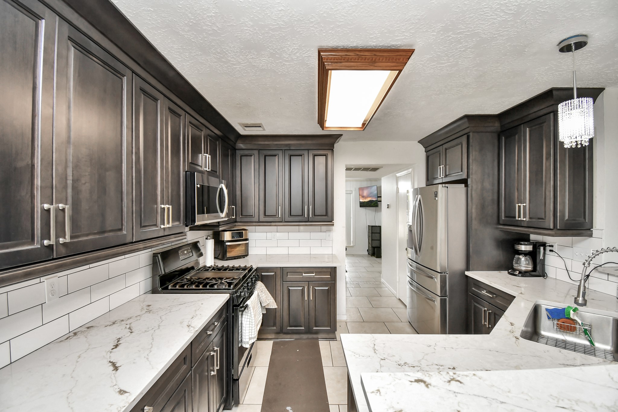 3402 Haydee Road Spring, TX 77388 - Photo 12 of 26 a kitchen with granite countertop a refrigerator stove sink and cabinets