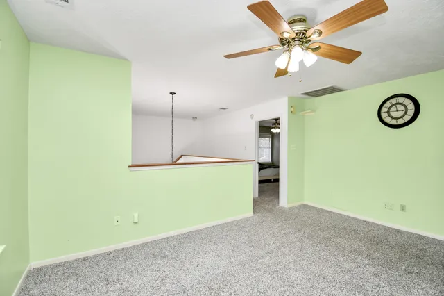 an aerial view of a house with a yard and trees