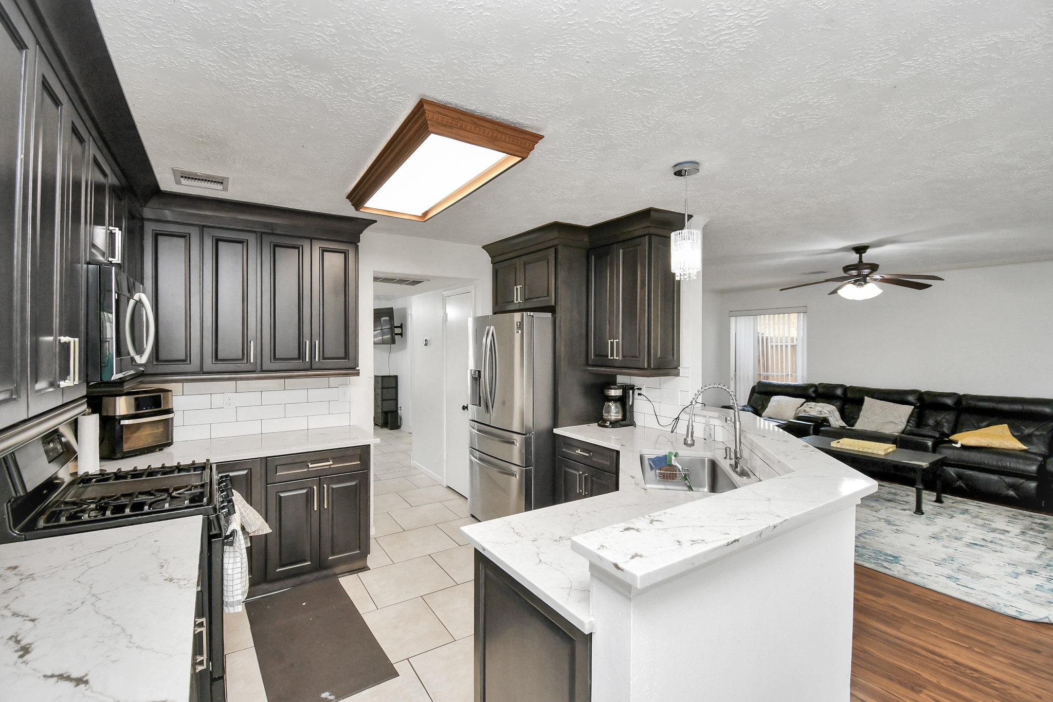 3402 Haydee Road Spring, TX 77388 - Photo 8 of 26 a kitchen with granite countertop a sink stove and refrigerator