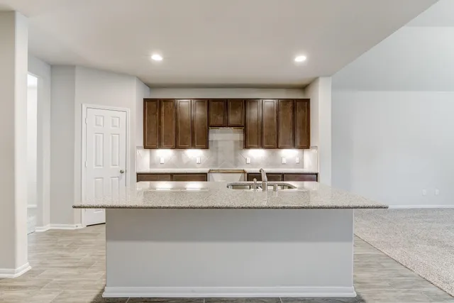 a view of a kitchen with granite countertop cabinets and a sink