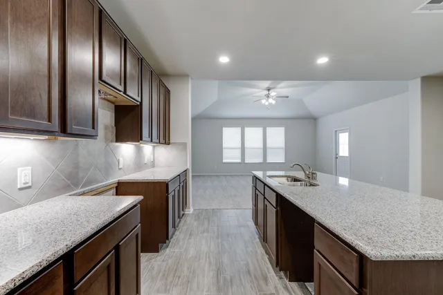 a kitchen with granite countertop stainless steel appliances and wooden cabinets