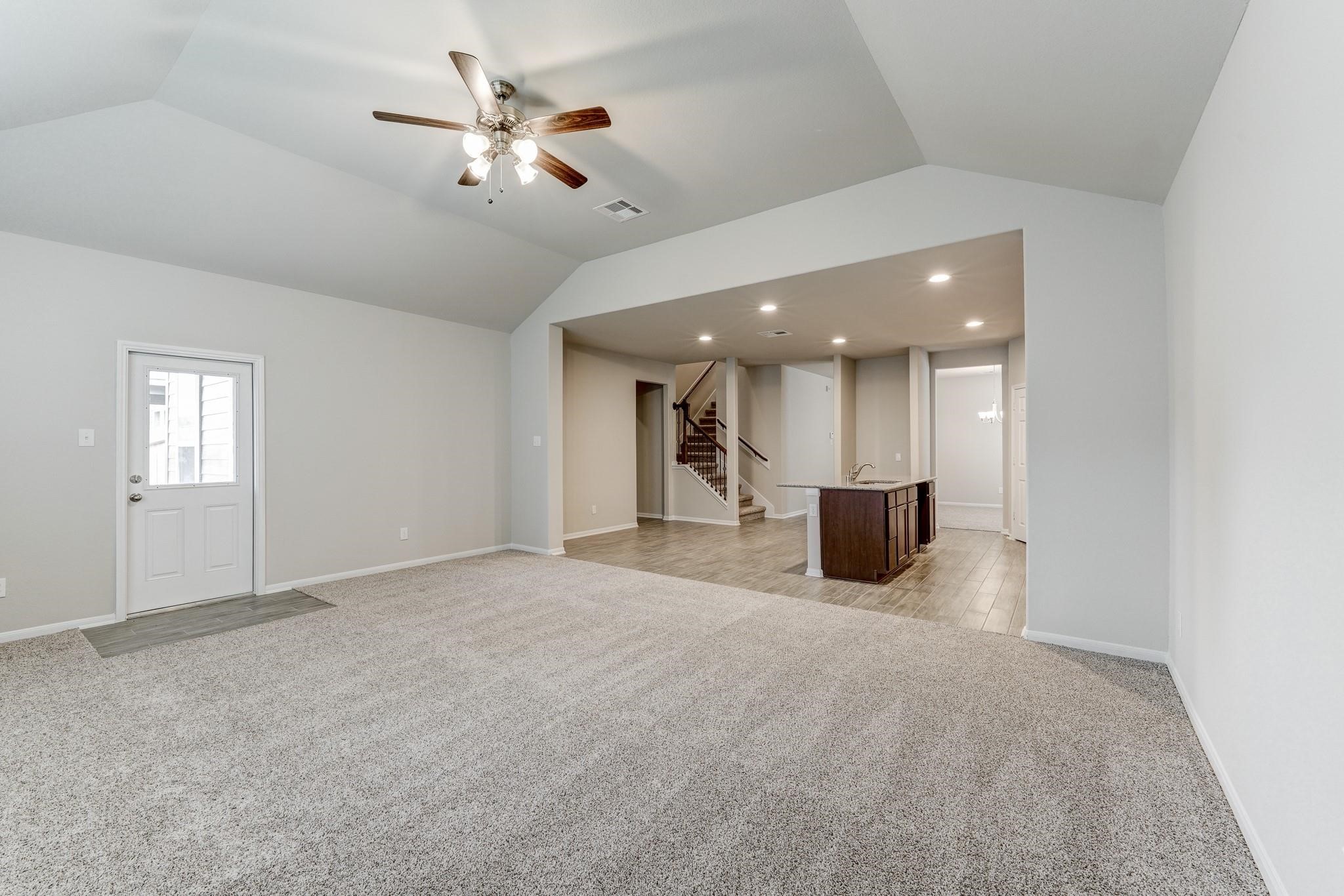 951 Willowick Road Houston, TX 77090 - Photo 6 of 9 a view of a livingroom with a kitchen and a ceiling fan