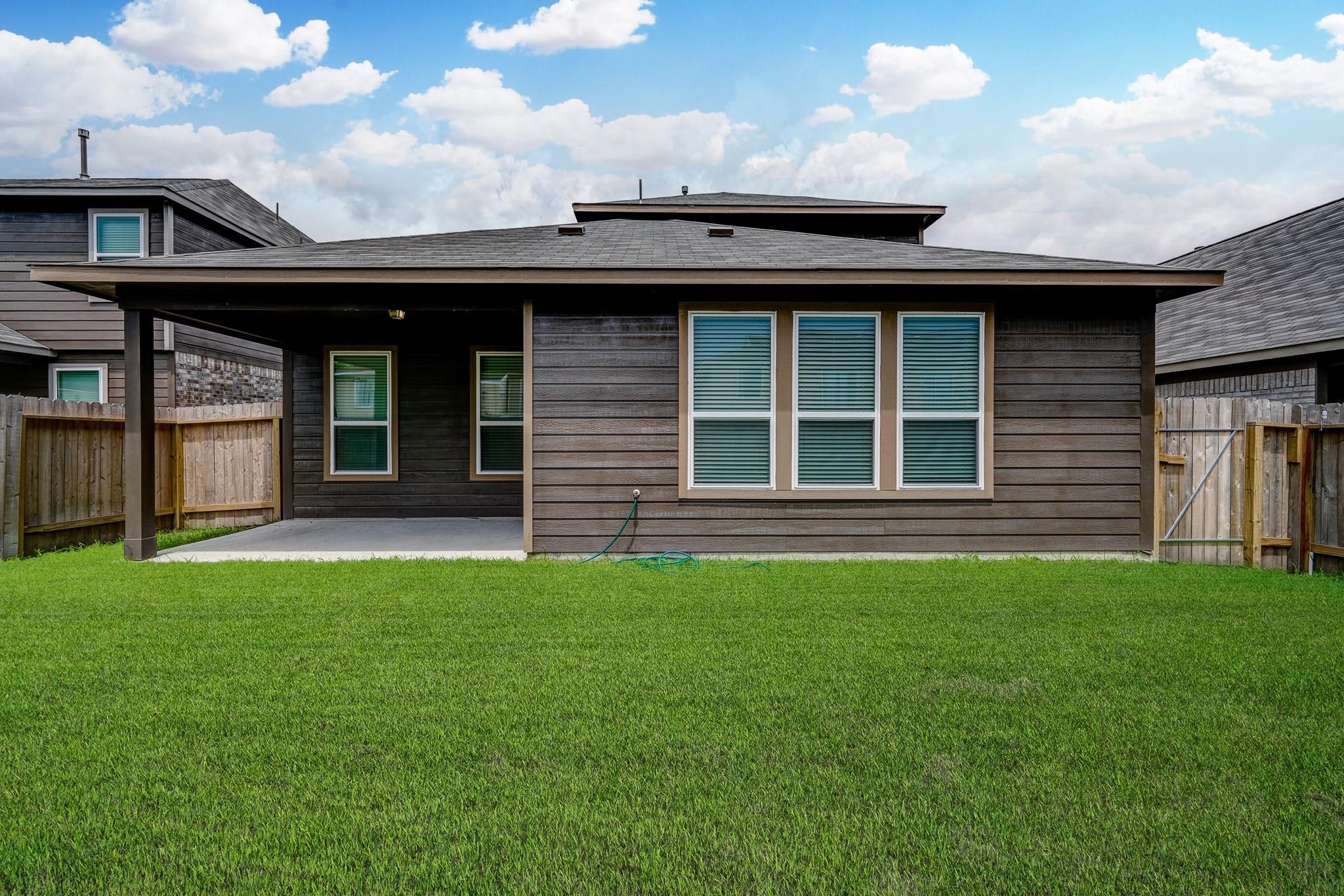 951 Willowick Road Houston, TX 77090 - Photo 9 of 9 a front view of a house with a garden