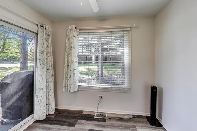 a view of a livingroom with wooden floor and a window