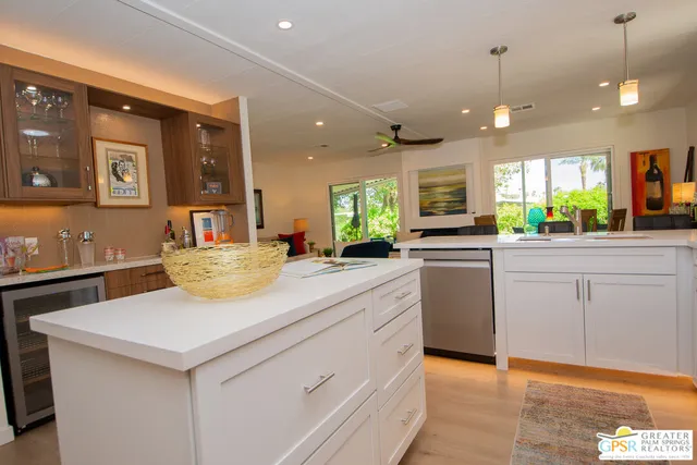 a kitchen with a sink window and cabinets