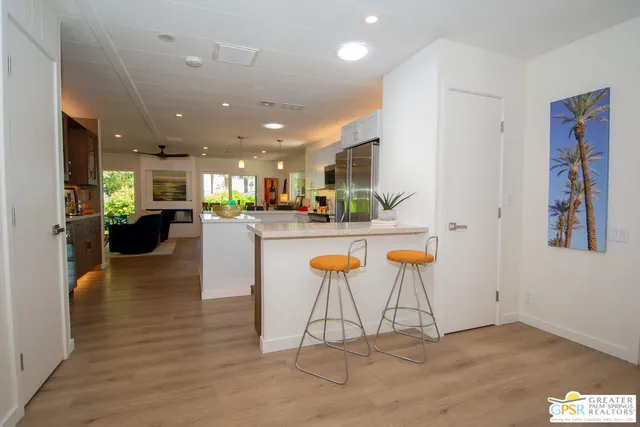 a view of kitchen with stainless steel appliances kitchen island granite countertop a living room