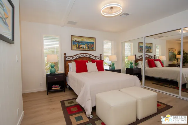 a bedroom with a bed and a couch