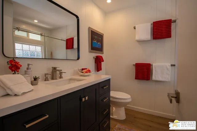 a bathroom with a sink vanity and a toilet
