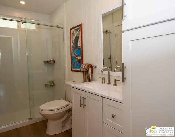 a view of a hallway with wooden floor and glass door