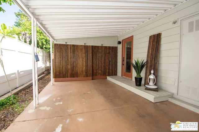 a view of a porch with wooden floor and iron stairs