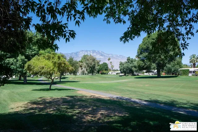 a view of a door and chair in the backyard
