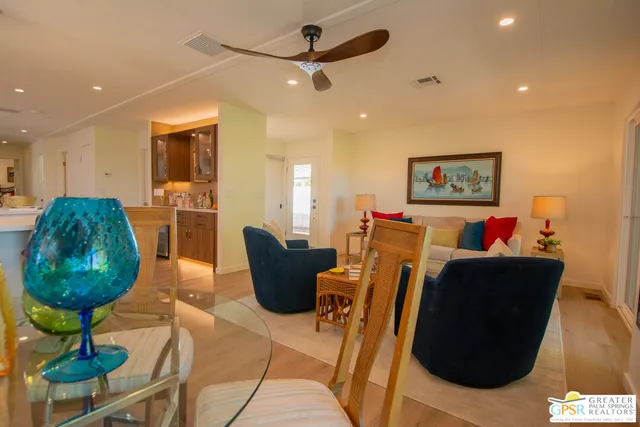 a living room with furniture a rug and a chandelier