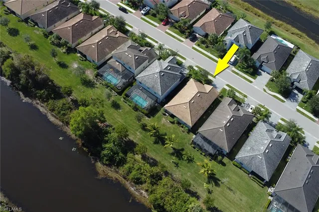an aerial view of a house with a yard