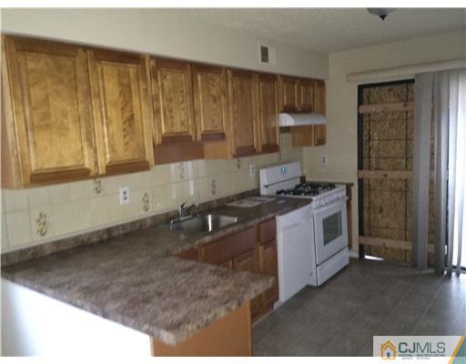 281 Rector Street Perth Amboy, NJ 08861 - Photo 2 of 10 a kitchen with a sink stove and cabinets