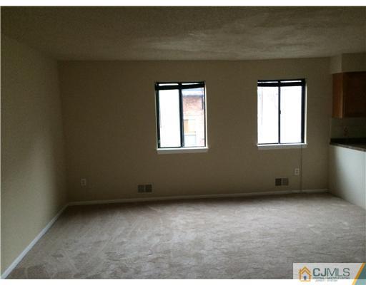 281 Rector Street Perth Amboy, NJ 08861 - Photo 4 of 10 an empty room with windows