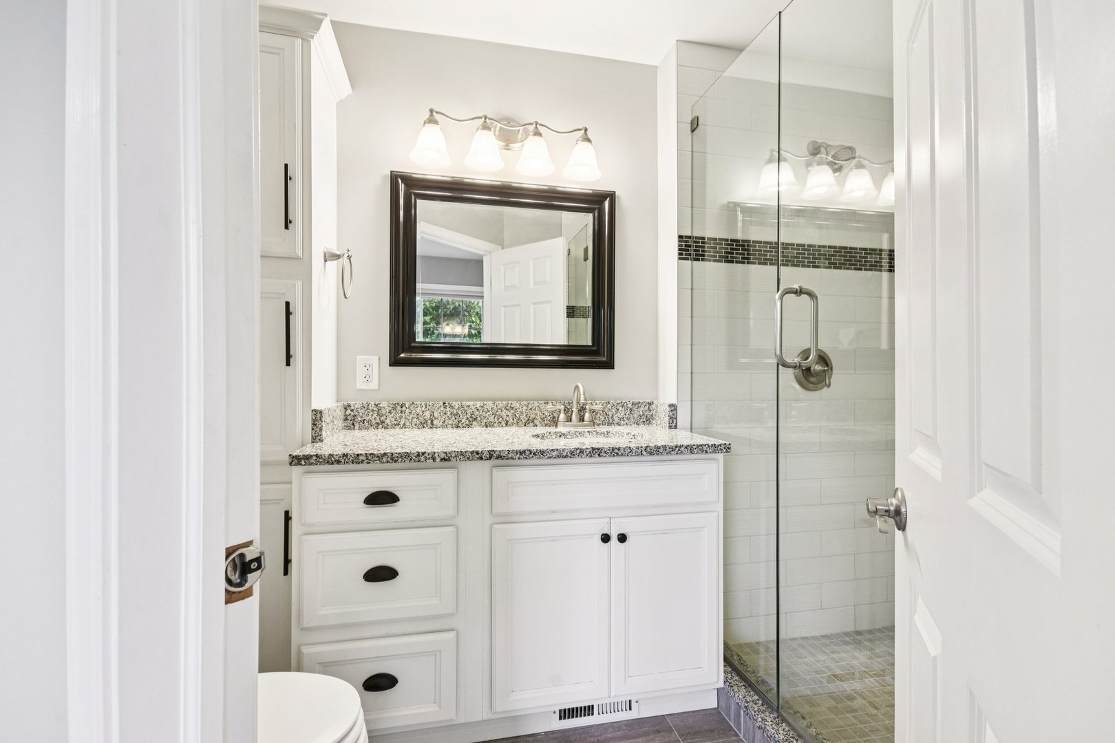 39W355 Baker Drive Geneva, IL 60134 - Photo 14 of 22 a bathroom with a granite countertop sink a mirror and shower