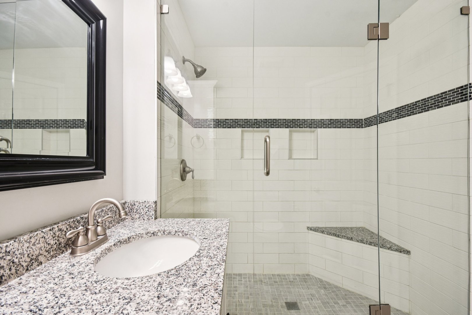 39W355 Baker Drive Geneva, IL 60134 - Photo 15 of 22 a bathroom with a granite countertop shower a mirror and a sink