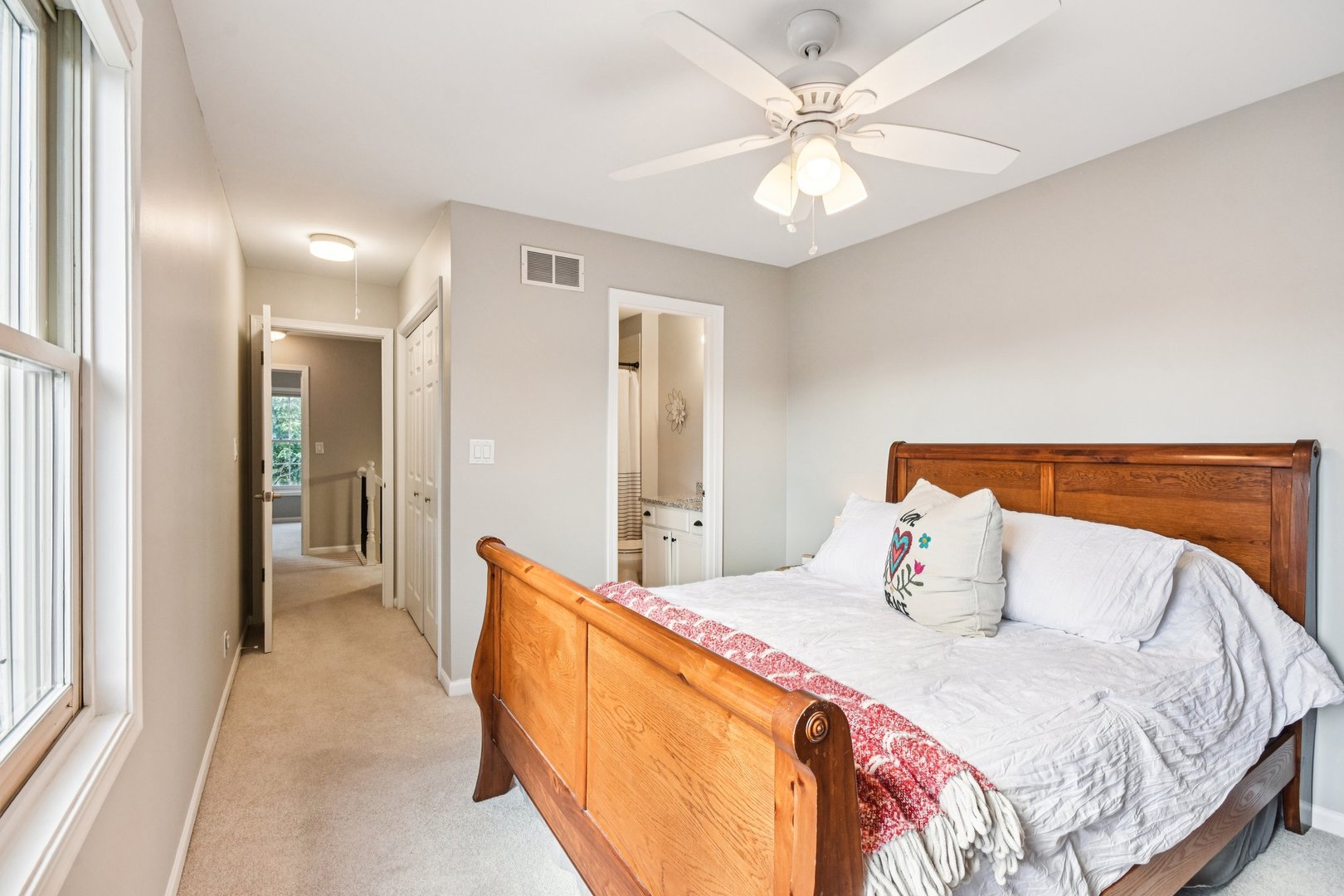 39W355 Baker Drive Geneva, IL 60134 - Photo 17 of 22 a bedroom with a bed and a chandelier