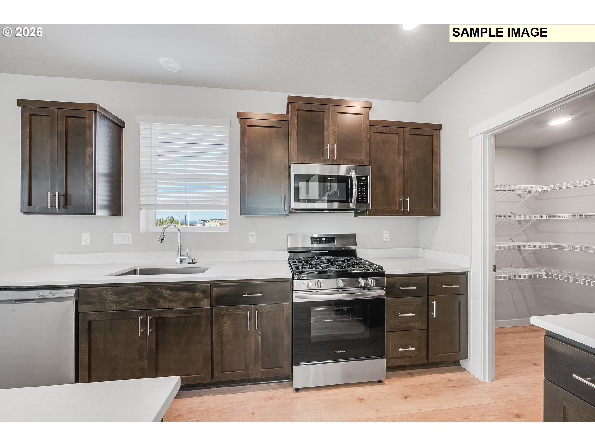 31775 Northwest Timeric Drive North Plains, OR 97133 - Photo 11 of 21 a kitchen with stainless steel appliances granite countertop a stove a sink and a microwave