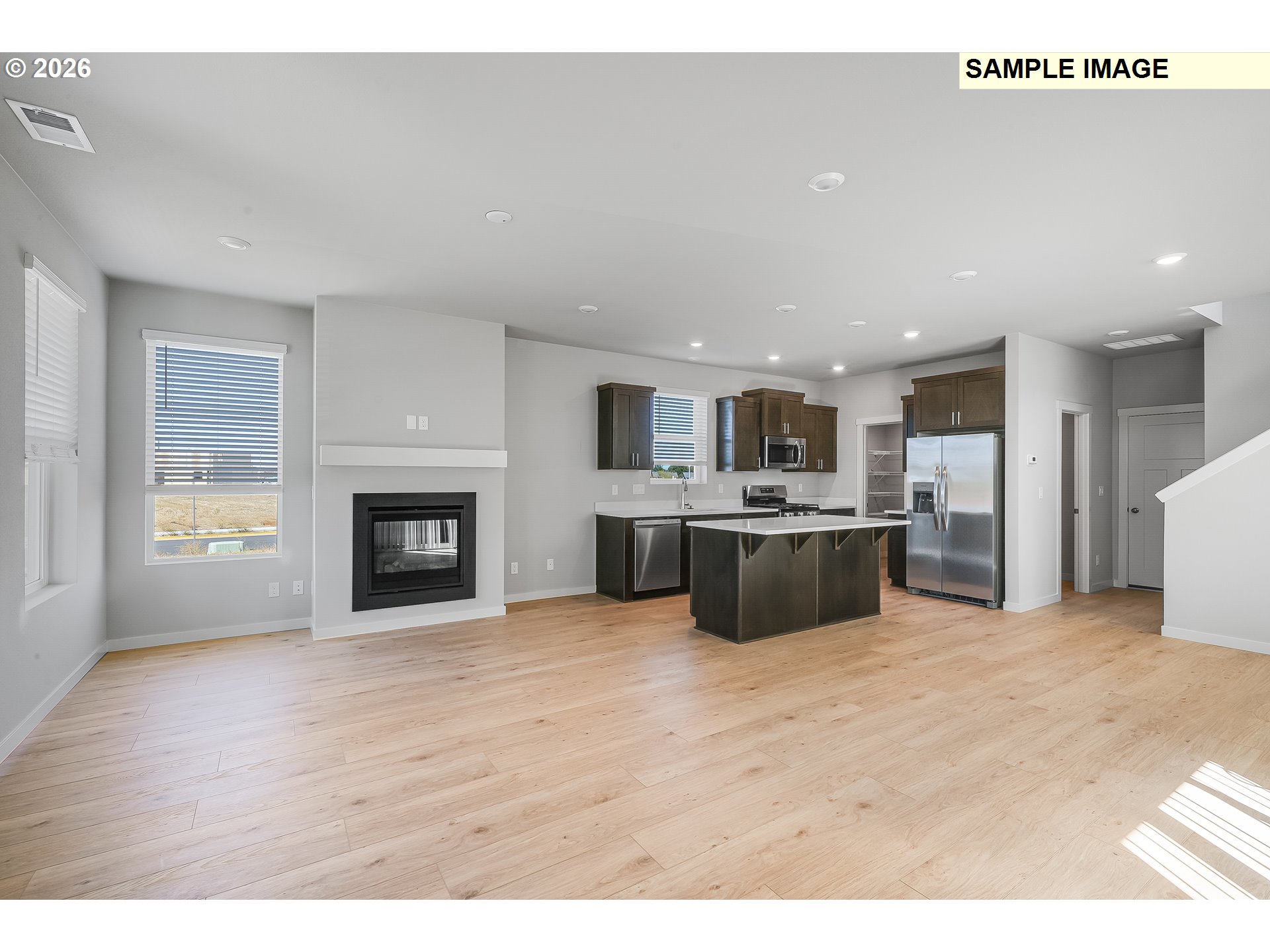 31775 Northwest Timeric Drive North Plains, OR 97133 - Photo 14 of 21 a large white kitchen with kitchen island a sink a stove and a refrigerator