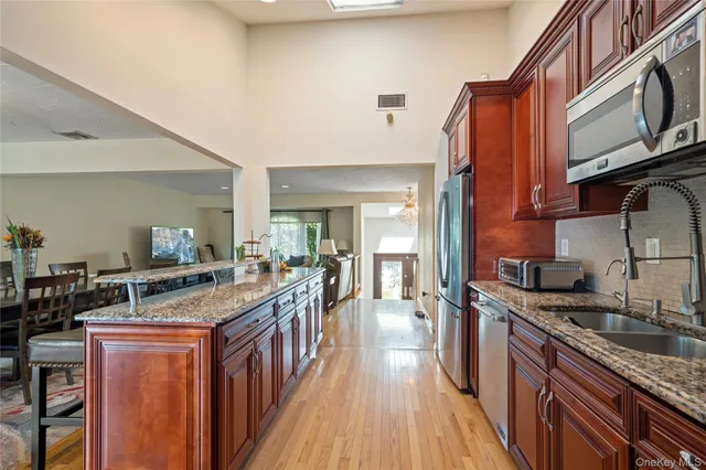 a kitchen with granite countertop lots of counter top space and stainless steel appliances