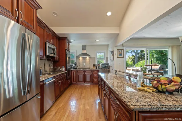 a kitchen with granite countertop lots of counter top space and stainless steel appliances