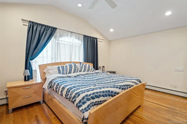 a bed sitting in a bedroom next to a window